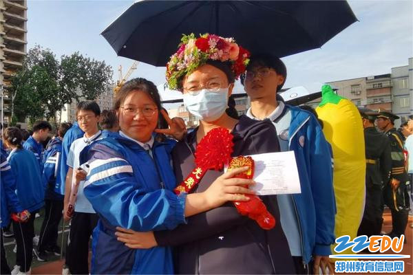 班主任戴上学生特制花环，与学生合影